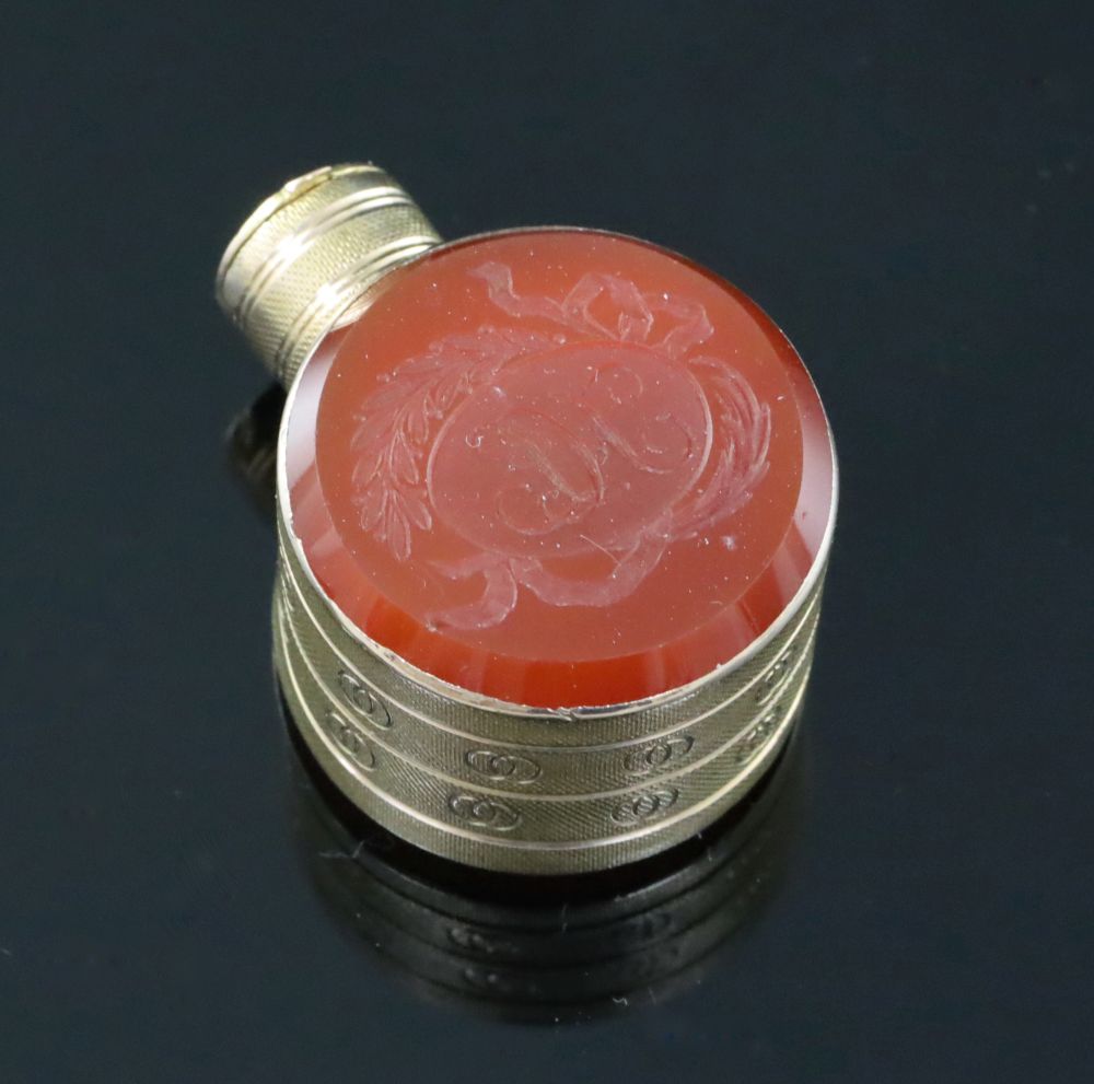 A small 19th century engraved gold and carnelian set moon shaped scent flask,